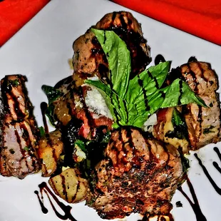 grilled meat and vegetables on a white plate