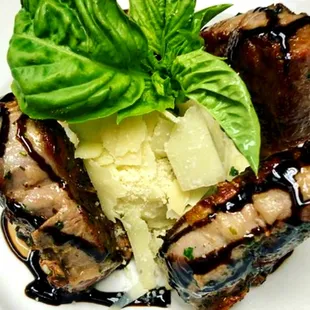 a plate of grilled meat and mashed potatoes