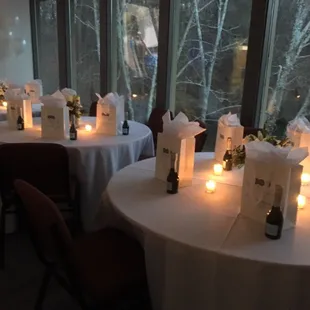 a table set up with wine bottles and candles