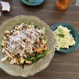 Caprese-style salad with grilled chicken and a side of fresh potato salad