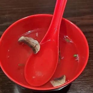 a bowl of soup with two spoons