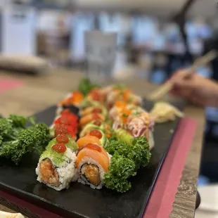 a plate of sushi and broccoli