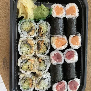 Lunch trio of sushi. Fresh and tasty. Eel roll on left. Salmon top. Tuna bottom.