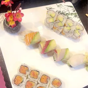a plate of sushi and rolls