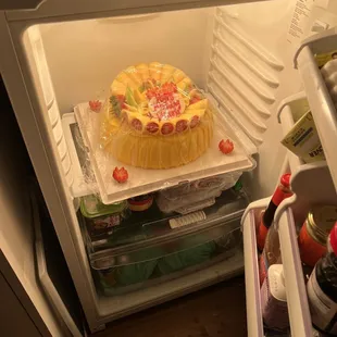 The 12 inch cake barely fitting in the fridge during a night out in the city