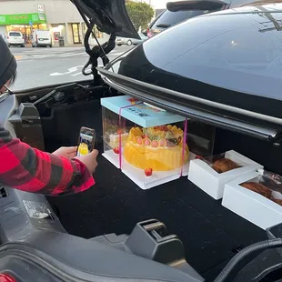 The cake barely fitting in the trunk!