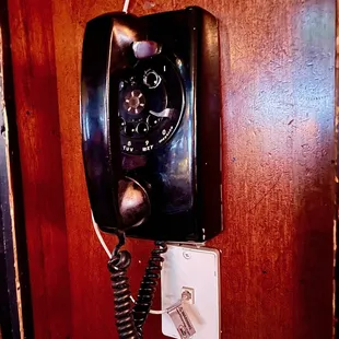 an old telephone on the wall