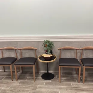 four chairs and a table in a waiting room