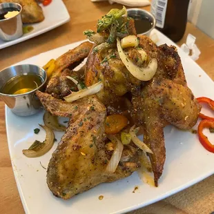 a plate of chicken wings and vegetables