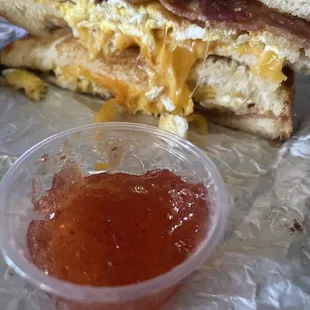 Bacon breakfast sandwich on sourdough with a side of local Alabama Sunshine spicy strawberry jam!