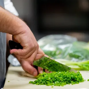 a chef chopping broccoli