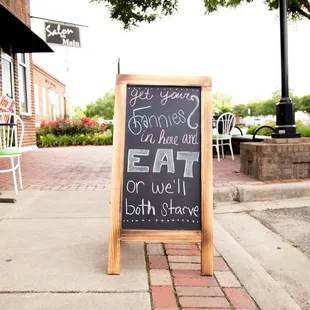 a chalkboard sign on a sidewalk