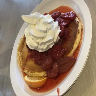 One pancake with whipped cream and strawberry