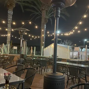 a patio with tables and chairs