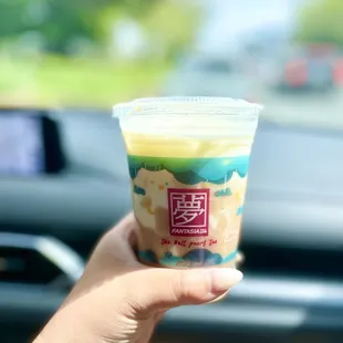 a hand holding a cup of coffee