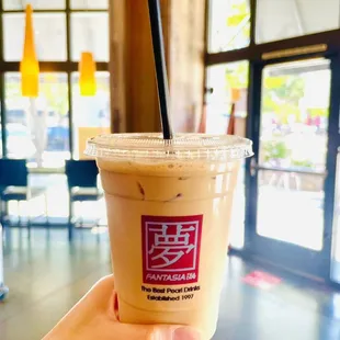 a hand holding a cup of coffee