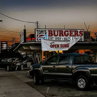 a truck parked in front of a restaurant
