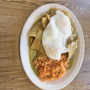 Chilaquiles plate served with eggs, rice and beans