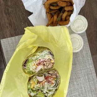 a wrap and fries on a table