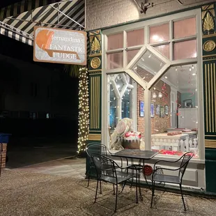 a table and chairs outside of a store