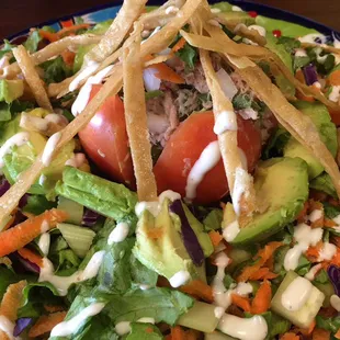 a plate of salad with tortillas