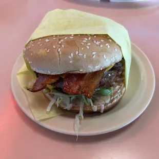 bacon, lettuce, lettuce, and cheese on a bun