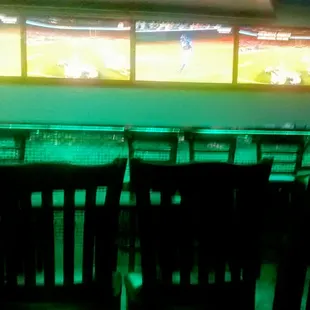 New bar setting against one wall. Neon-green glow.