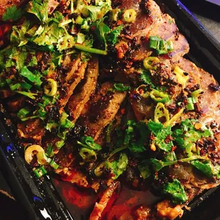 a tray of meat and vegetables