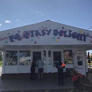two people standing outside of a store