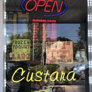 an open sign in the window of a restaurant