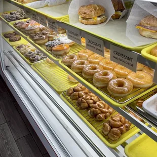 a variety of donuts in a display case
