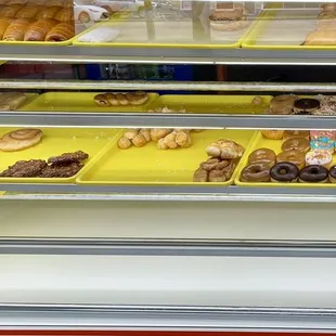 Few doughnuts and breakfast selections. (Breakfast sandwiches and kolaches)