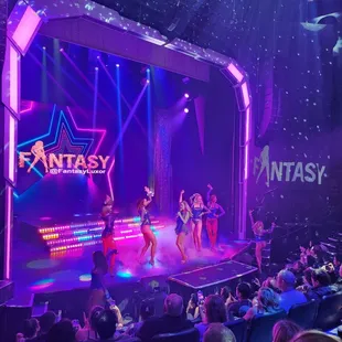 a group of dancers performing on stage