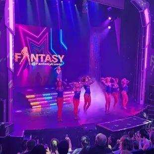 a group of dancers performing on stage