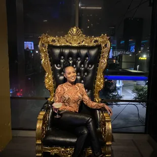 a woman sitting on a chair in a room