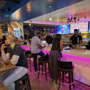 a group of people sitting at a bar