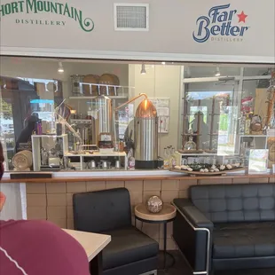 a man sitting in a chair in front of a bar