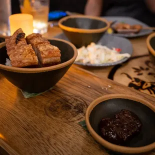 a wooden table with bowls of food