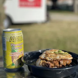 a plate of food and a can of beer