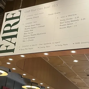 a large sign hanging from the ceiling of a restaurant