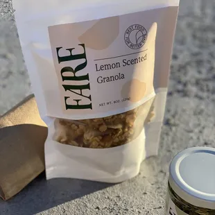 a bag of lemon scented granola next to a jar of granola