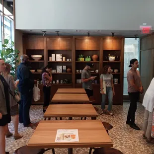 a group of people standing around a table