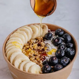 Acai Bowl. Organic Acai, Granola, Banana, Blueberries, Coconut Flakes, Honey Drizzle