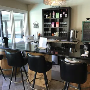 a bar with black chairs