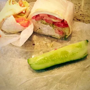 Chicken salad in a pita wrap with salad mix Italian dressing cheese and tomatoes