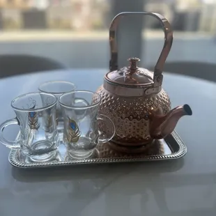 a teapot and cups on a tray