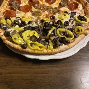 Half pepperoni and sausage, half olives mushrooms and banana pepper yummmm