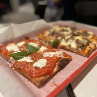 two slices of pizza on a tray