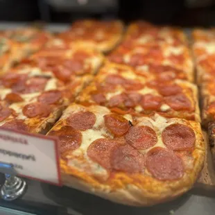 pepperoni pizza in a display case