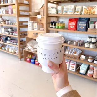 a hand holding a cup of coffee